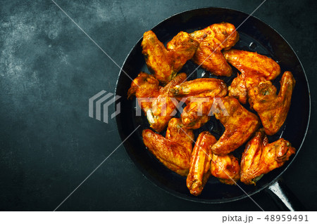 Chicken wings grilled in sauce on pan 48959491