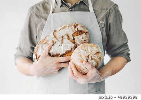 Baker or chef holding fresh made bread Baker or chef holding fresh made bread 48959598