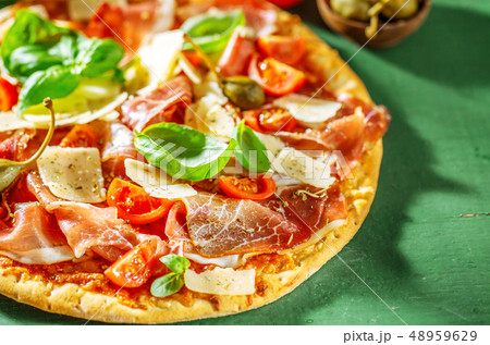 Appetizing italian pizza with prosciutto 48959629