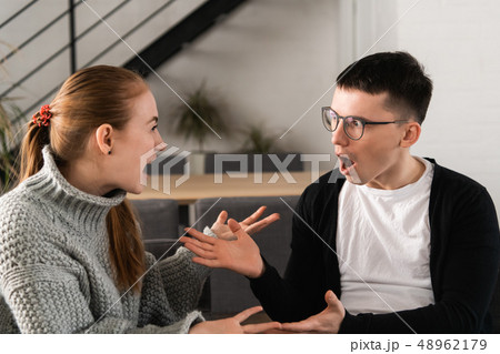 Attractive angry couple fighting and shouting at each other 48962179