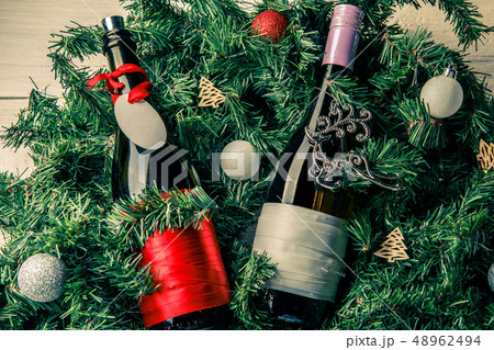 Photo of spruce branches with two bottles of wine, blank greeting card 48962494
