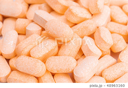 Heap of Vitamin C tablets 48963160