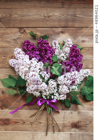 Fresh lilac flowers on the wooden vintage background . Vintage floral background with spring flowers 48964021