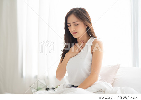 Asian Woman with Acid Reflux. 48964727