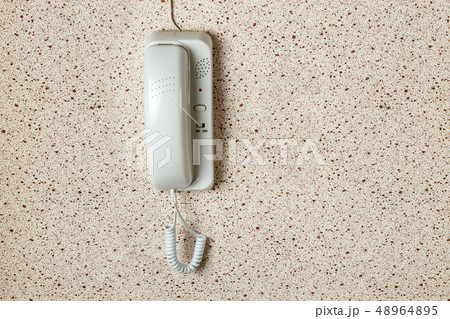 white intercom on the wall 48964895
