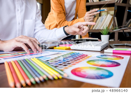 Two colleagues creative graphic designer working on color select 48966140