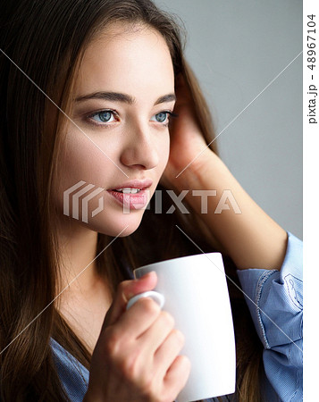 Beautiful young woman hold in arms white cup 48967104
