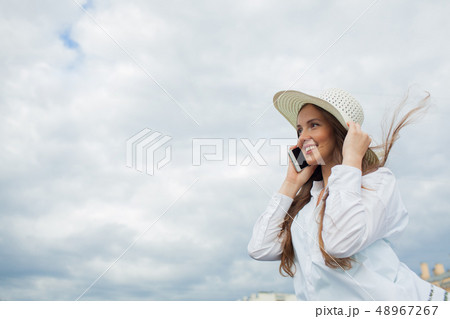 Beautiful smiling girl talking on the phone. 48967267