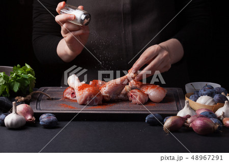 A woman chef prepares a chicken. A woman chef prepares a chicken. 48967291