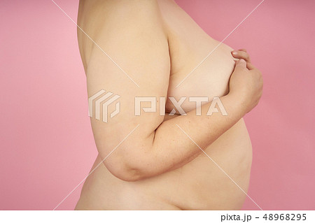Naked senior woman with fat belly and overweight on coral background Naked senior woman with fat belly and overweight on coral background 48968295