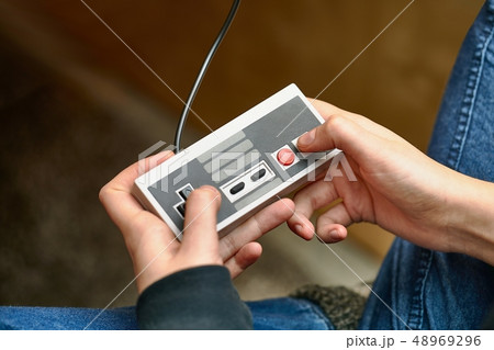 Playing an old gaming console 48969296
