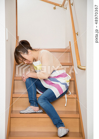 階段で転んで膝を打った女性 48970367