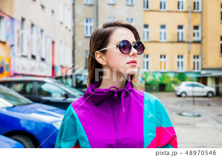Young woman in jacket of 90s style stay at  back yard  48970546