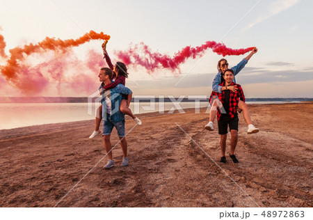 young friends running with hand flare or fusee young friends running with hand flare or fusee 48972863