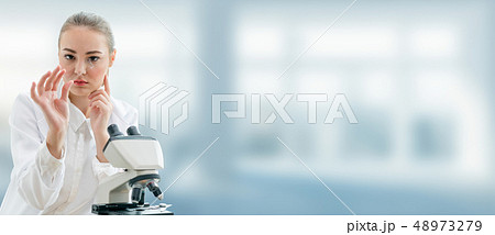 Scientist researcher uses microscope in laboratory Scientist researcher uses microscope in laboratory 48973279