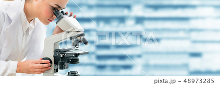 Scientist researcher uses microscope in laboratory Scientist researcher uses microscope in laboratory 48973285