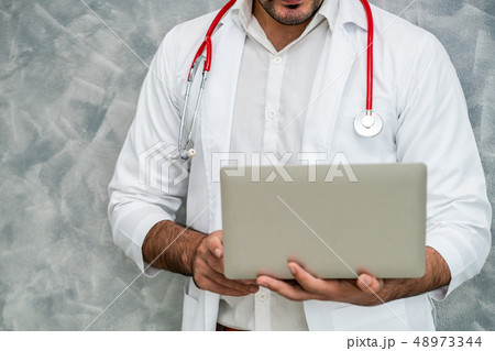 Doctor using laptop computer at the hospital. Doctor using laptop computer at the hospital. 48973344