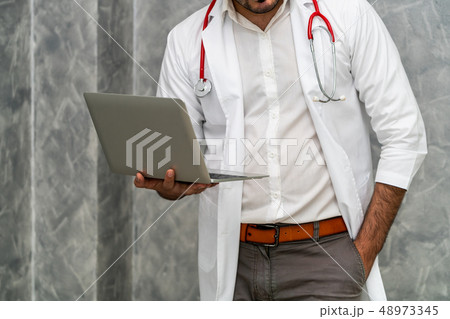 Doctor using laptop computer at the hospital. 48973345