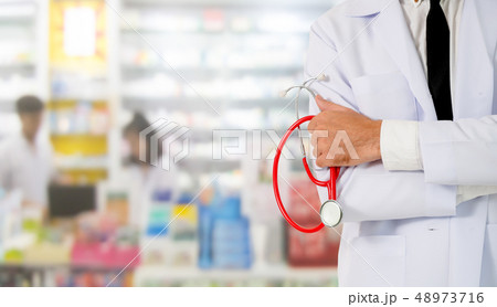 Male pharmacist working at the pharmacy. 48973716