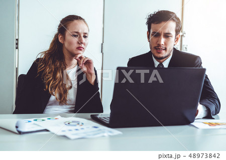 Unhappy serious businessman and businesswoman. Unhappy serious businessman and businesswoman. 48973842