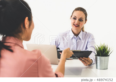 Two young business women meeting for interview. 48974152
