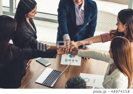 Teamwork businesswomen joining hands in meeting. 48974158