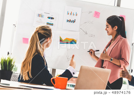 Multicultural working group in teamwork meeting. 48974176