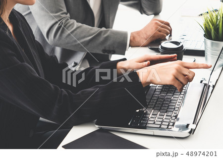 Businessman and businesswoman working in office. 48974201