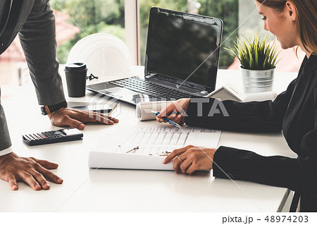 Architect and engineer working with drawing. Architect and engineer working with drawing. 48974203