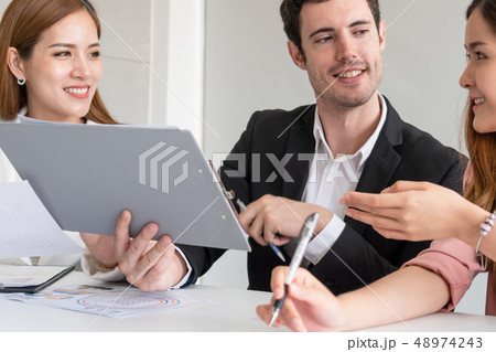 Businessman and businesswomen working in office. 48974243