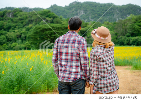 Happy couple take a romantic walk on the hills. Happy couple take a romantic walk on the hills. 48974730