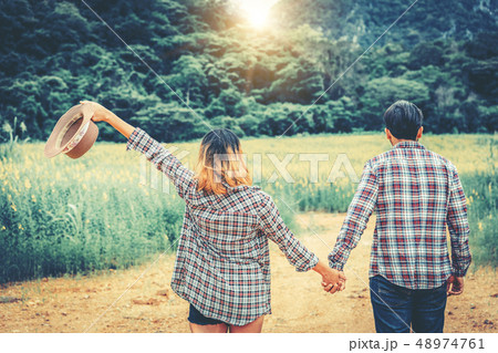 Happy couple take a romantic walk on the hills. 48974761