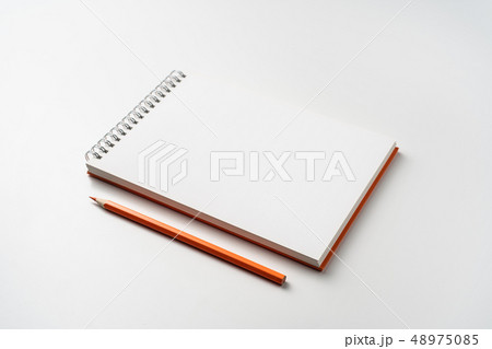 perspective view of spiral orange notebook perspective view of spiral orange notebook 48975085