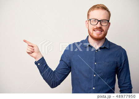 Happy man pointing with finger Happy man pointing with finger 48977950