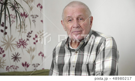 Very old man portrait in thoughts home looking at camera 4k 48980217