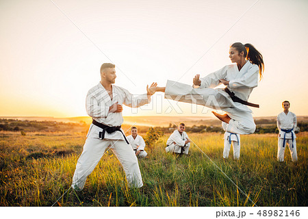 Female karate fighter trains kick in flight Female karate fighter trains kick in flight 48982146