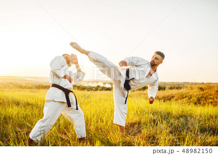 Two karate fighters, kick in the stomach 48982150
