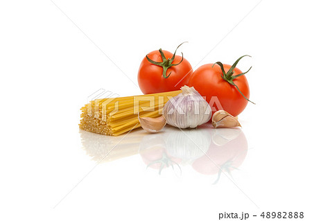 spaghetti, tomatoes and garlic on a white spaghetti, tomatoes and garlic on a white 48982888