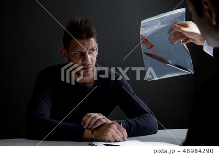 Police showing a knife with blood as a murder 48984290