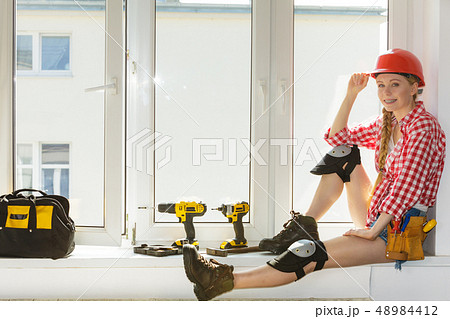 Girl using some power tools for work at home 48984412