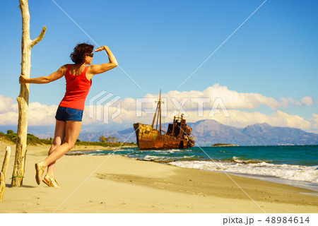 Tourist woman on beach enjoying vacation 48984614