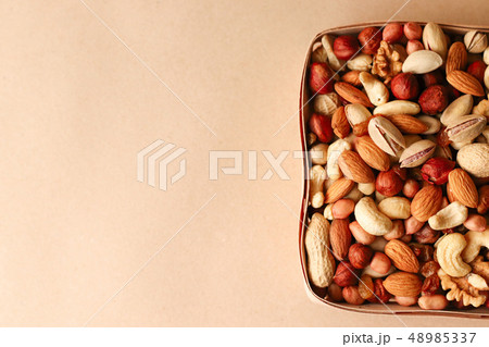 Dried fruits and nuts mix in a wooden bowl. Dried fruits and nuts mix in a wooden bowl. 48985337