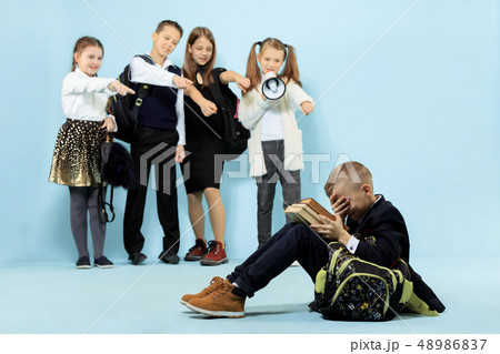 Little boy sitting alone on floor and suffering an act of bullying. 48986837