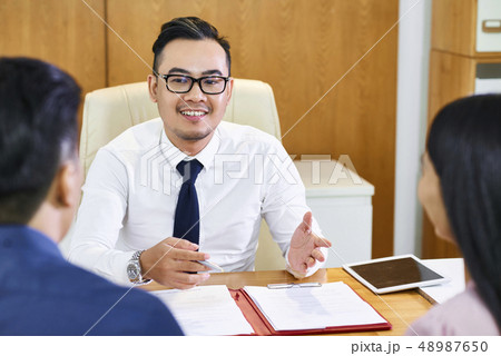 Estate agent explaining contract details Estate agent explaining contract details 48987650