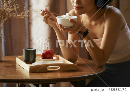Woman eating granola Woman eating granola 48988172