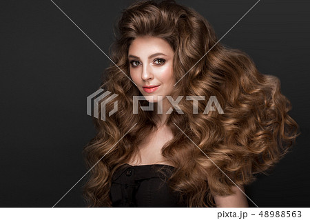 Beautiful brown-haired girl with a perfectly curls hair, and classic make-up. Beauty face. Beautiful brown-haired girl with a perfectly curls hair, and classic make-up. Beauty face. 48988563