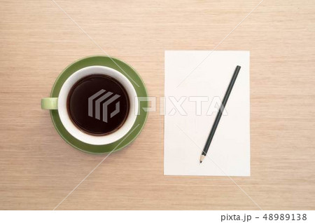 A green cup of coffee on the background of a table A green cup of coffee on the background of a table 48989138