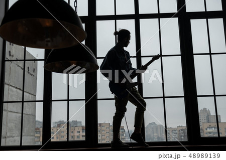 Instrumentalist having rehearsal at home in the evening 48989139