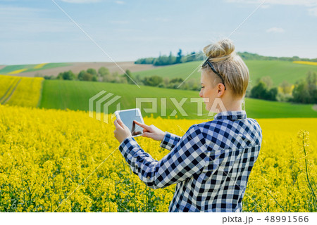 Agriculture Farmer Using Digital Tablet Examining Crops 48991566