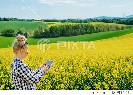 Agriculture Farmer Using Digital Tablet Examining Crops 48991571